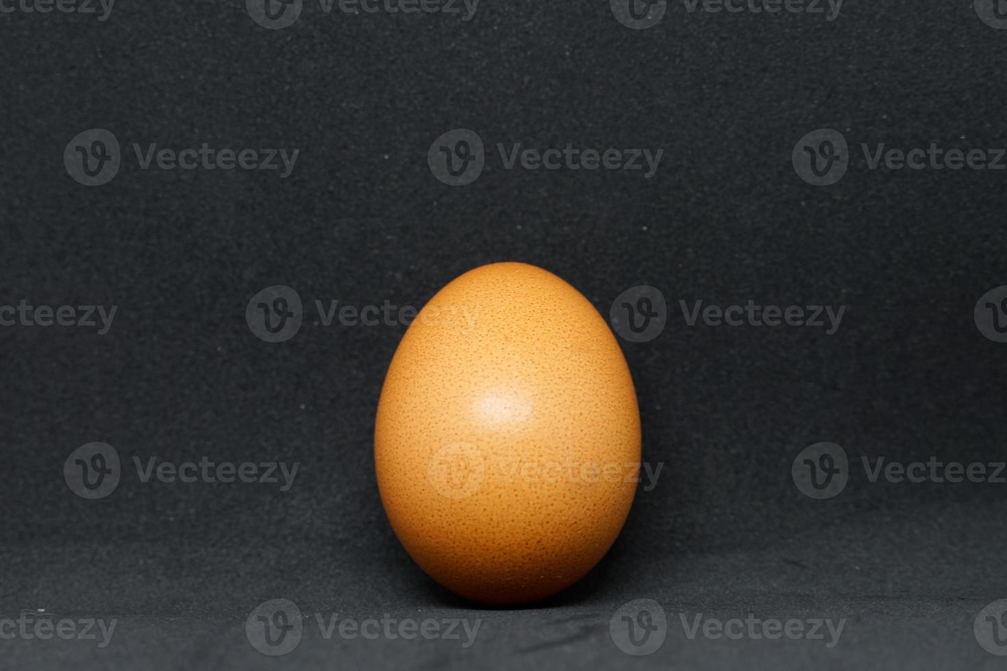 fresh chicken eggs laid out on a black background. photo