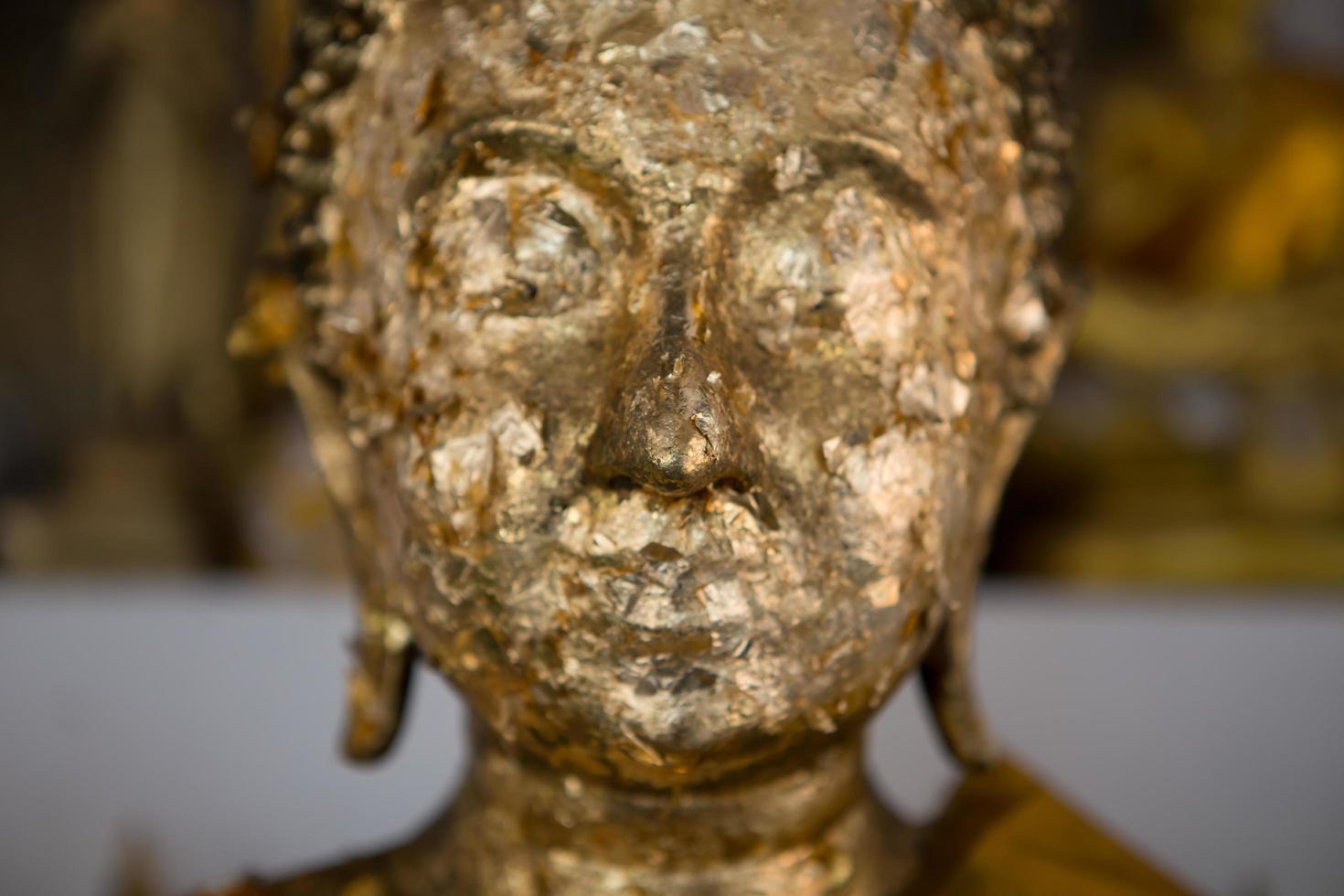 close up Buddha statue gilded in the measure photo