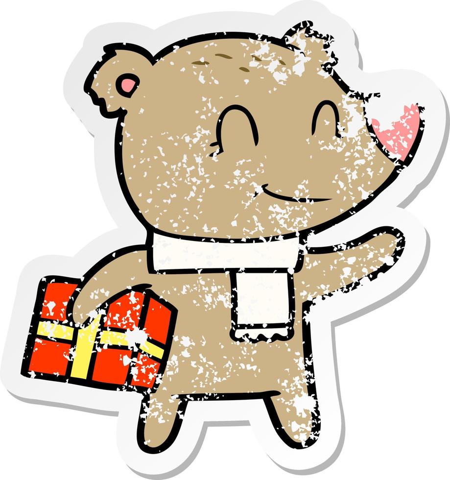 distressed sticker of a friendly bear with xmas gift and scarf vector