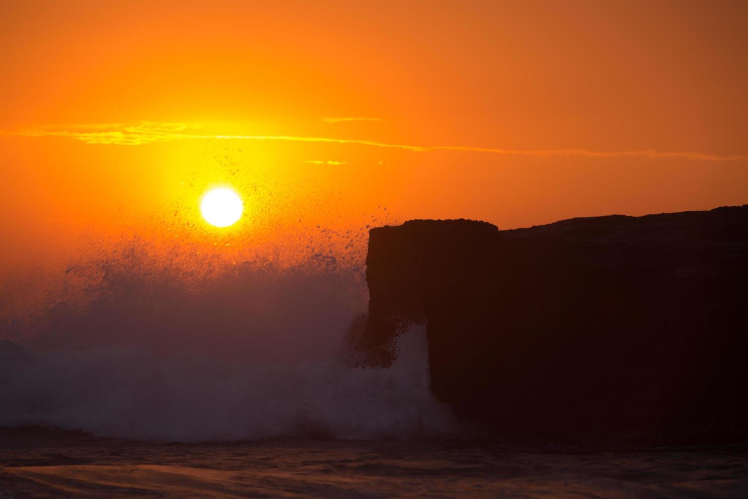 sunset over hindu temple Pura Tanah Lot, Bali, Indonesia photo