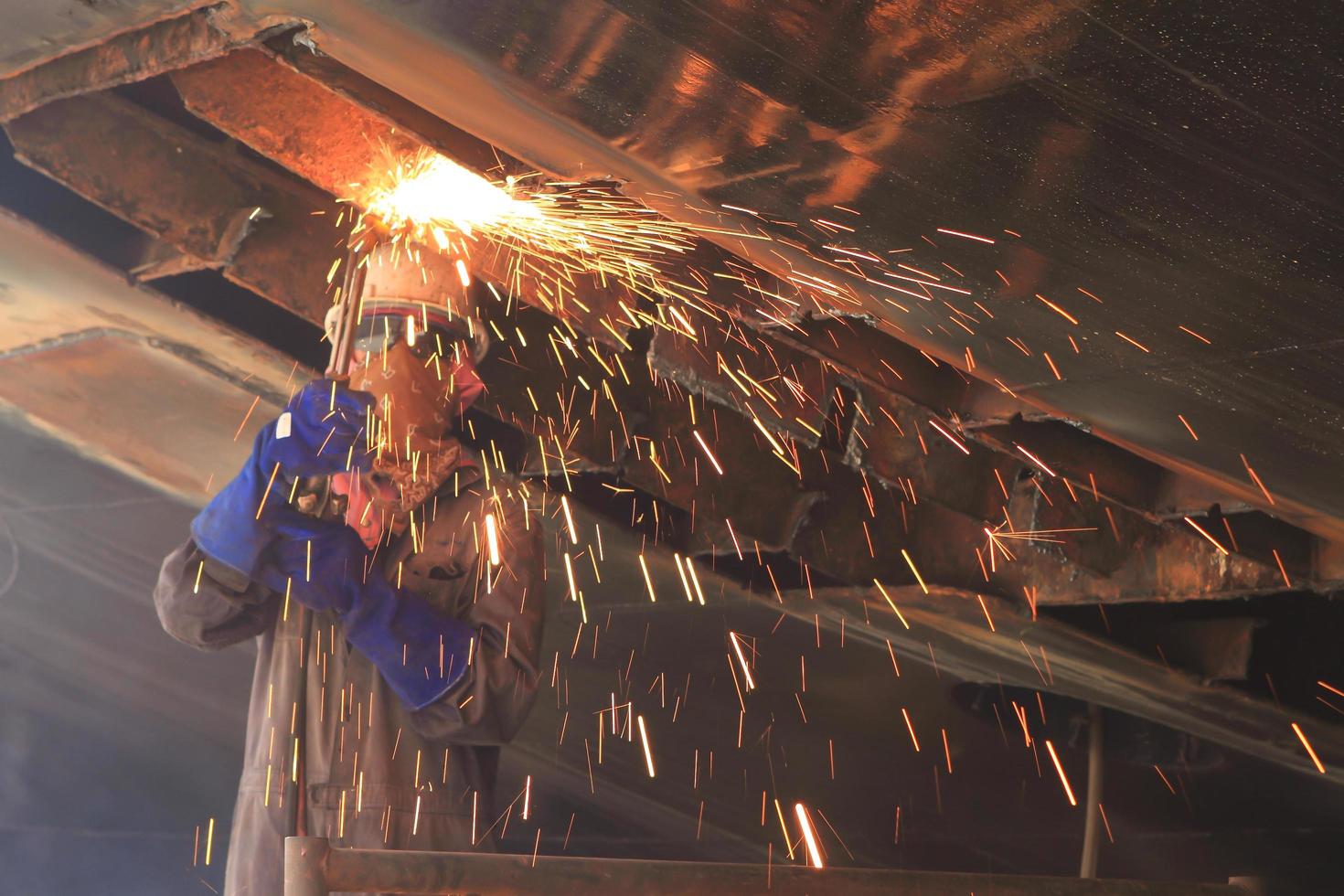 a welder working a torch at shipyard photo