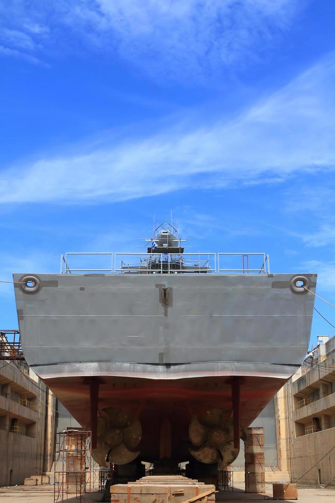 A large cargo ship is being renovated in shipyard photo
