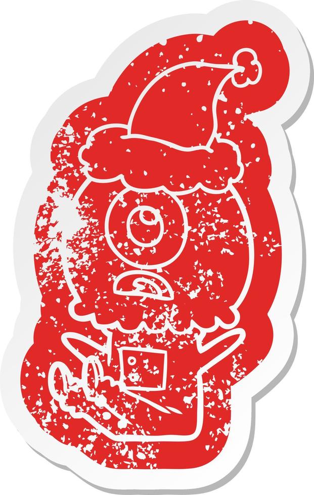 cartoon distressed sticker of a cyclops alien spaceman wearing santa hat vector