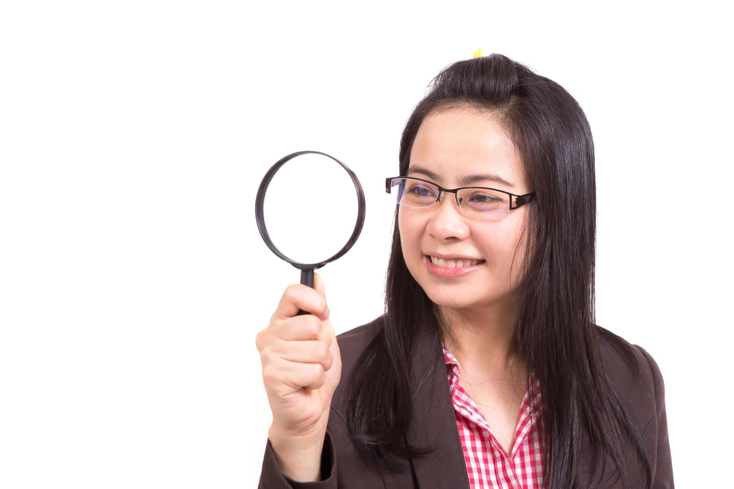 woman with magnifying glass isolated on a white background photo