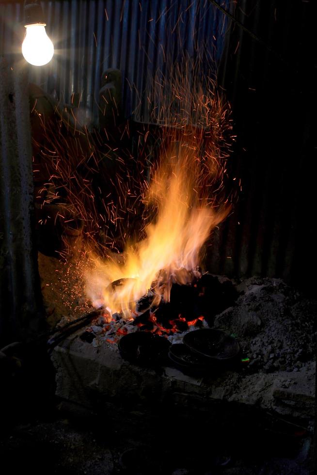 forge fire in blacksmith's where iron tools are crafted photo