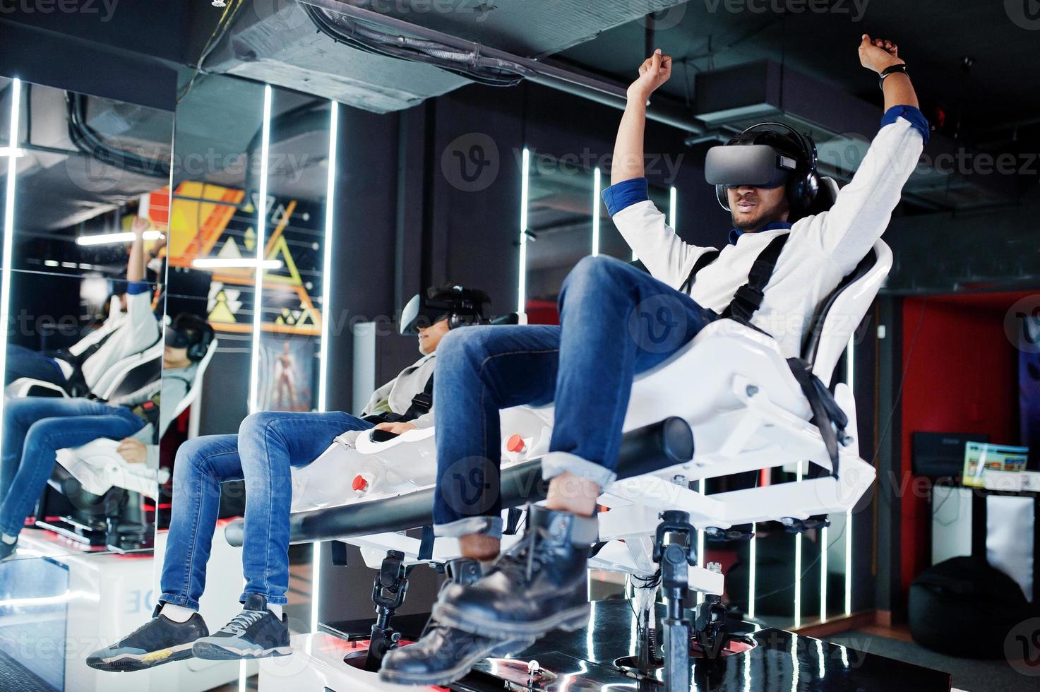 Two young indian people having fun with a new technology of a vr headset at virtual reality simulator. photo