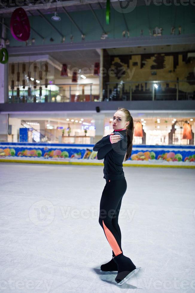 Figure skater woman at ice skating rink. photo