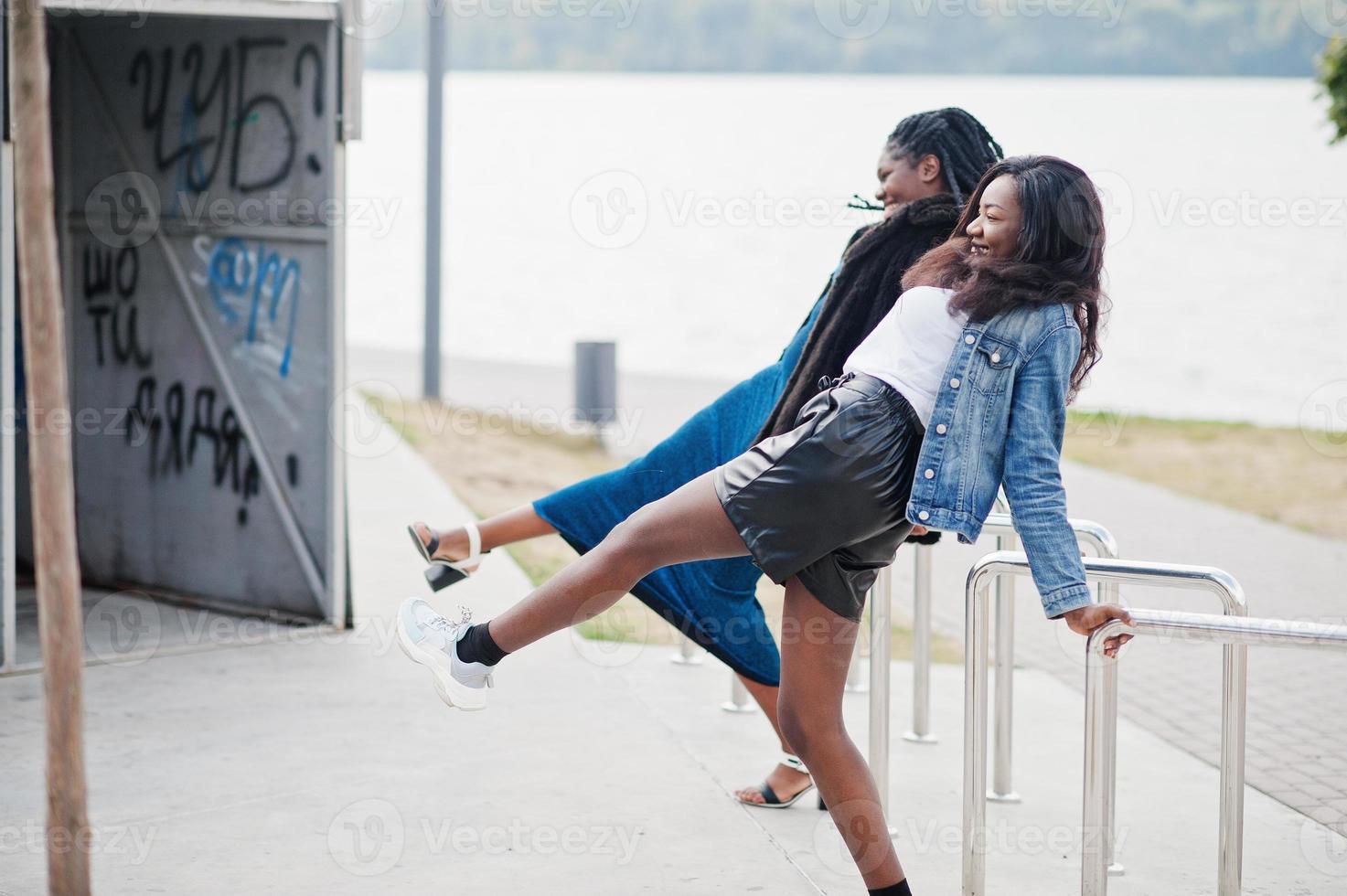 Two african american dark skinned friends female. One of them plus size model, second slim. Having fun and spending time together. photo