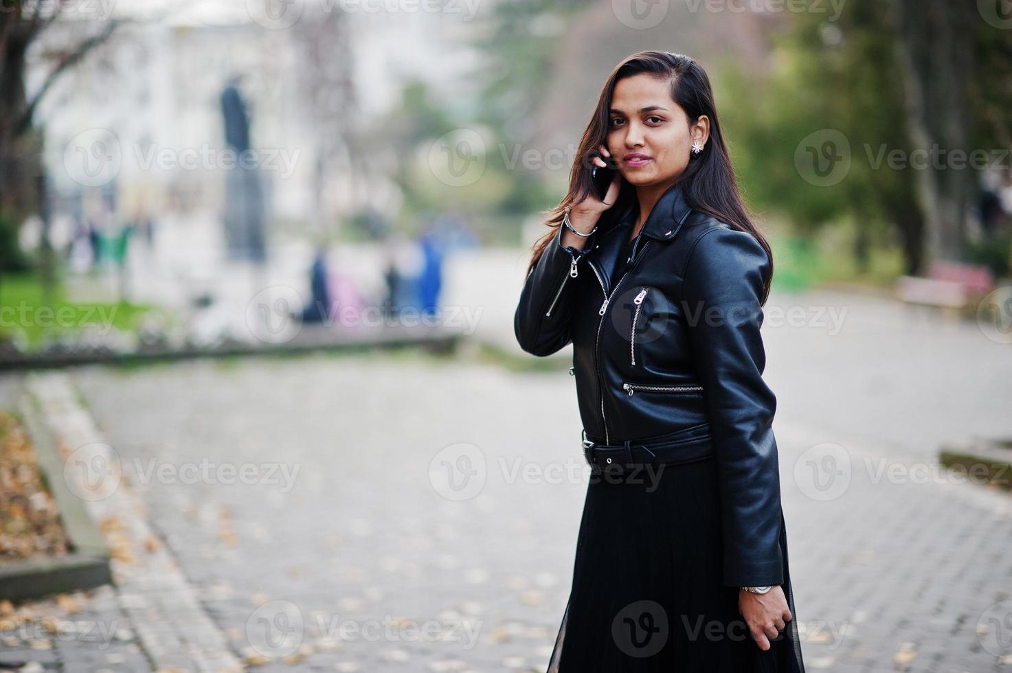 Pretty indian girl in black saree dress and leather jacket posed ...