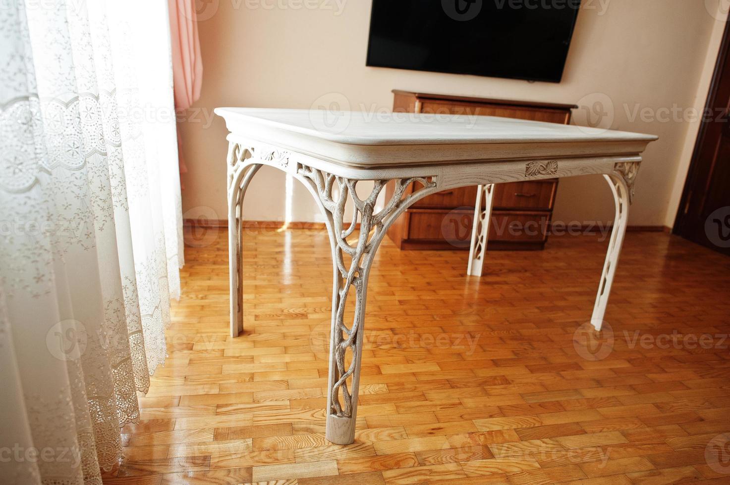 White wooden carved table in flat. photo