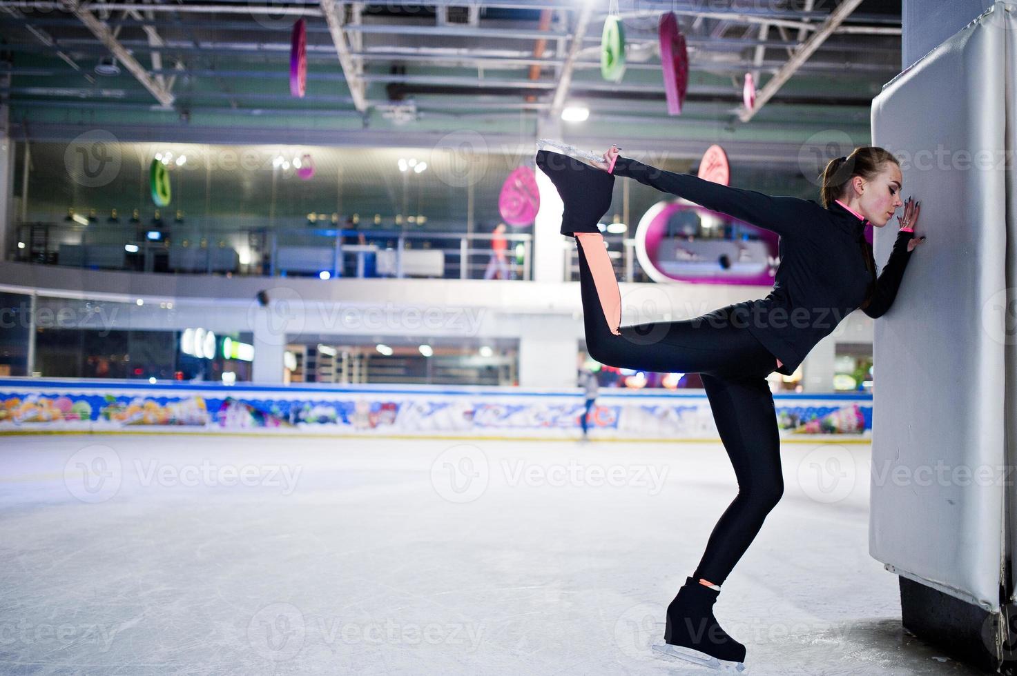 Figure skater woman at ice skating rink. photo