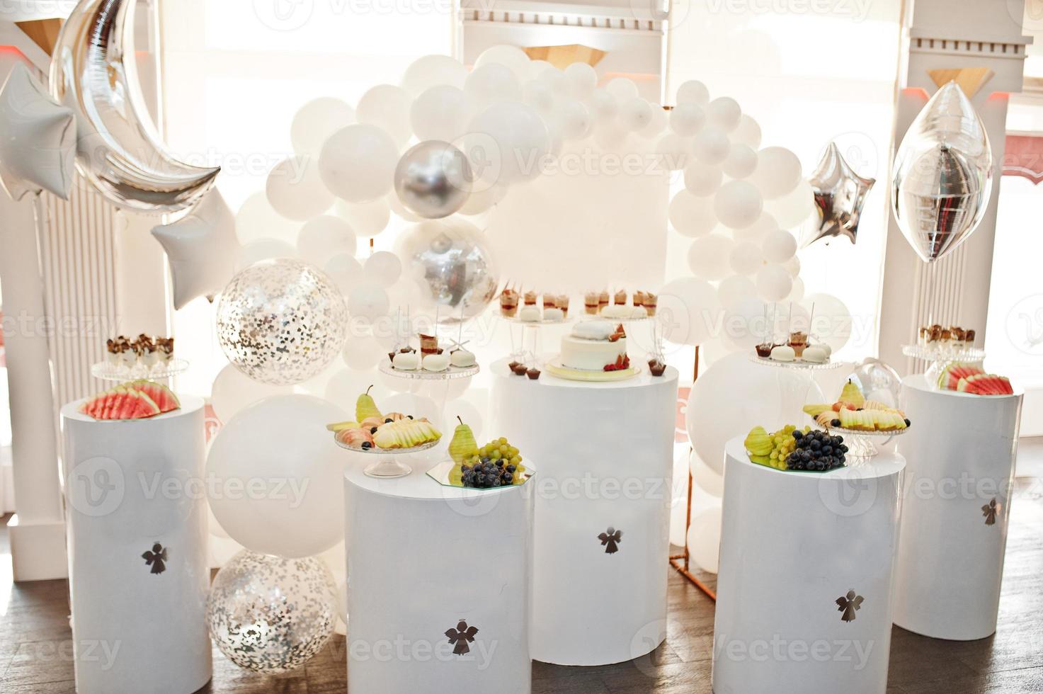 Candy bar decoration setup with delicious cakes and sweets. photo