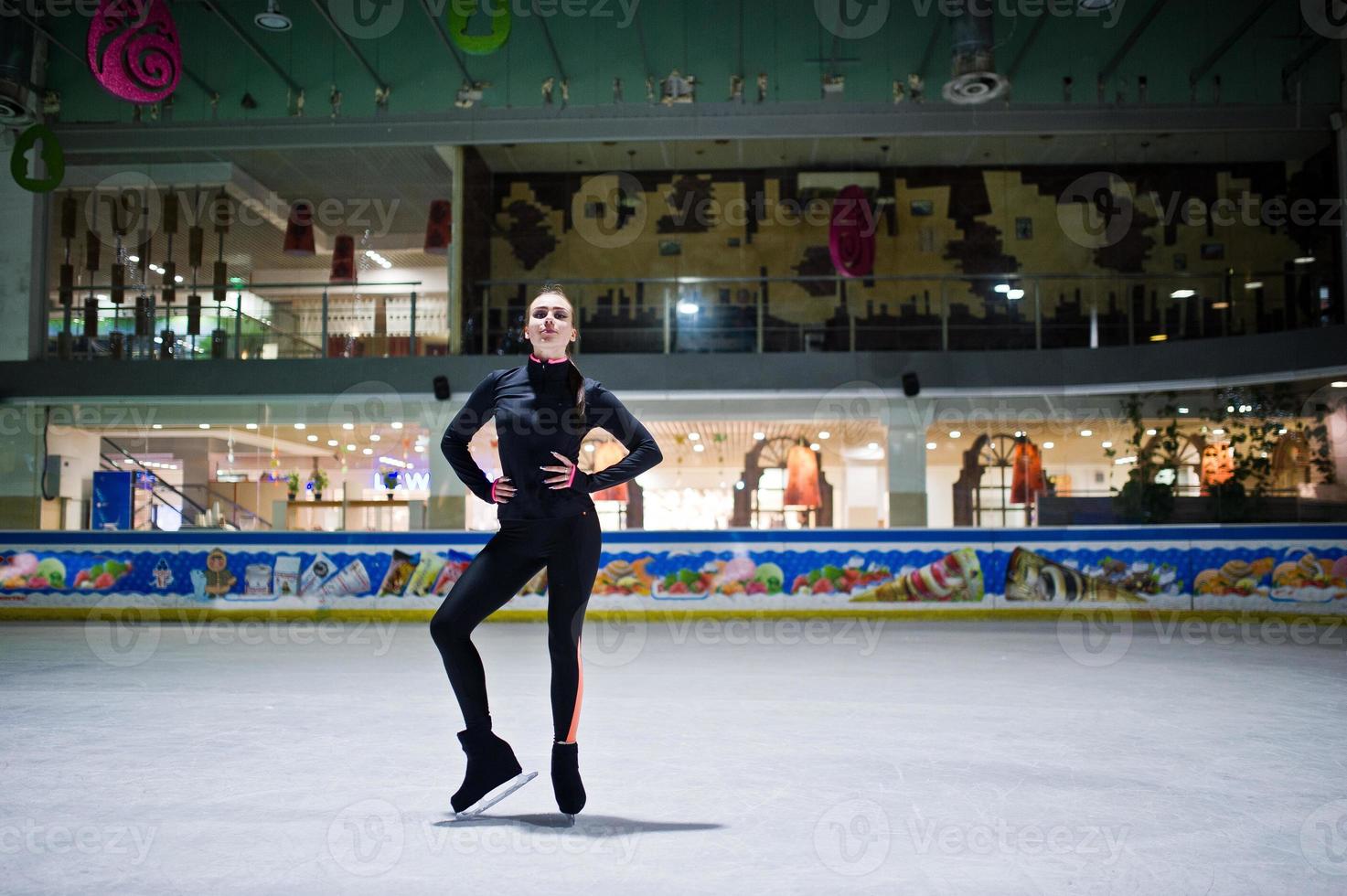 Figure skater woman at ice skating rink. photo