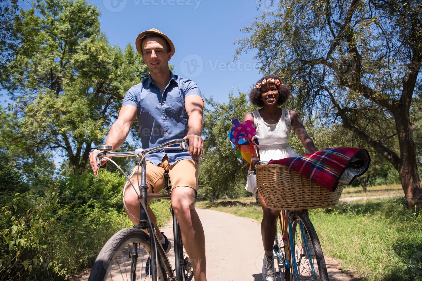 Young multiethnic couple having a bike ride in nature photo