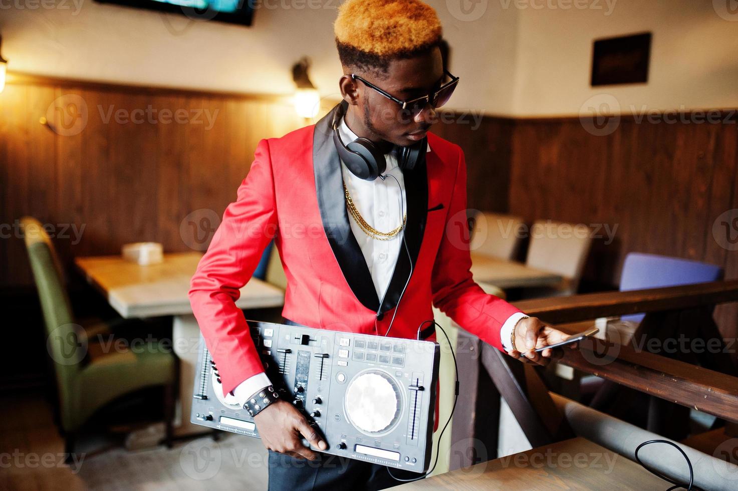 Fashion african american man model DJ at red suit with dj controller. photo