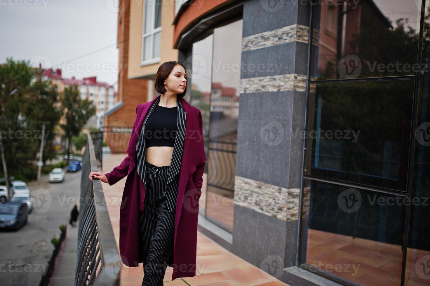 A tall leggy young beautiful and elegant model woman at claret coat. photo