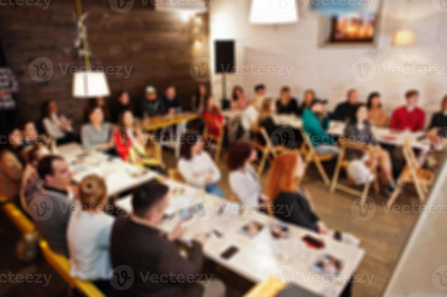 Master class and study concept. Abstract blurred photo of conference or seminar room with speaker on the stage.