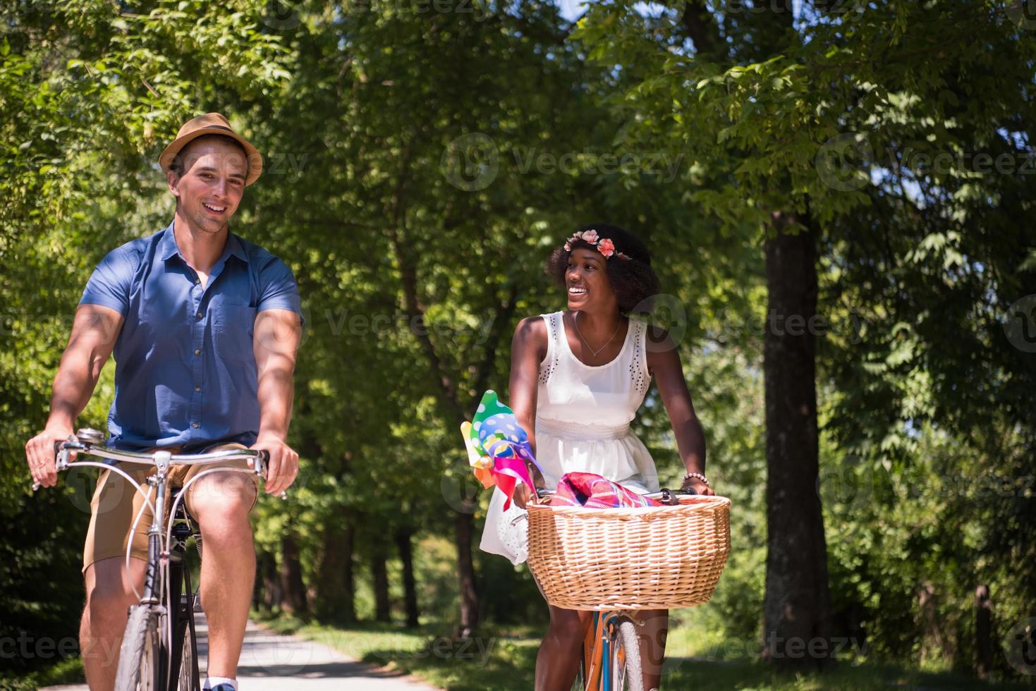 Young multiethnic couple having a bike ride in nature photo