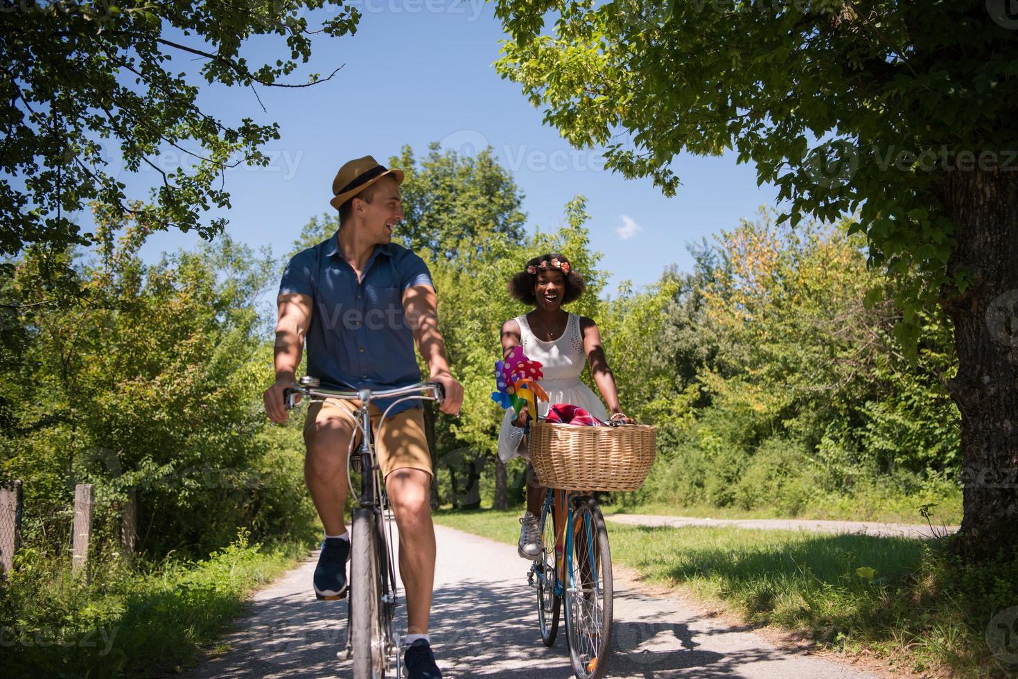 Young multiethnic couple having a bike ride in nature photo