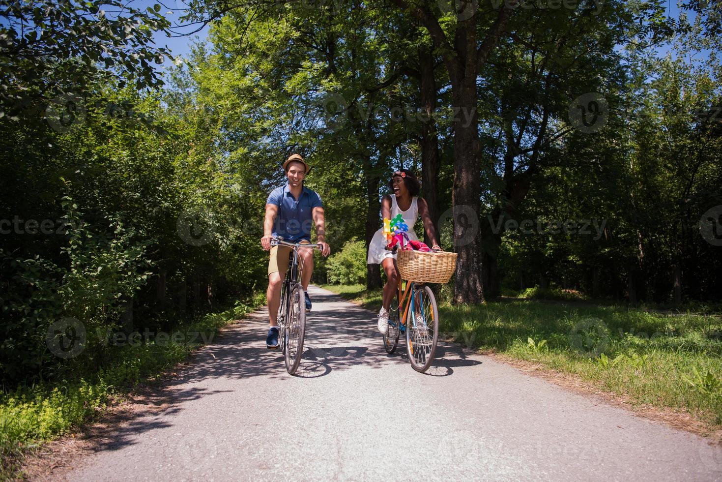 Young multiethnic couple having a bike ride in nature photo