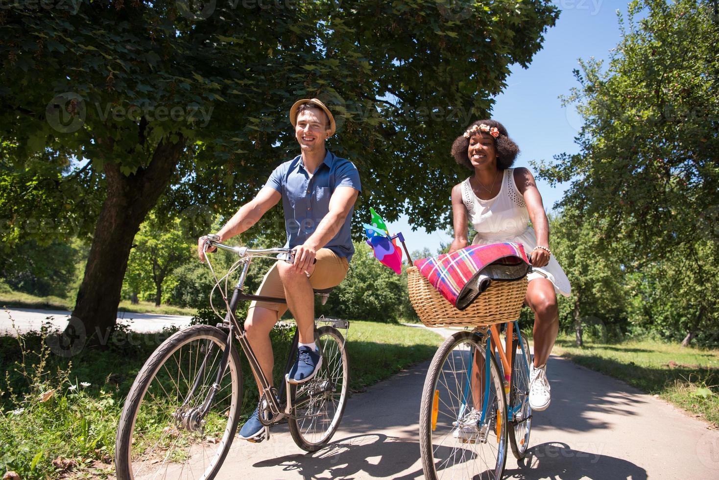 Young multiethnic couple having a bike ride in nature photo