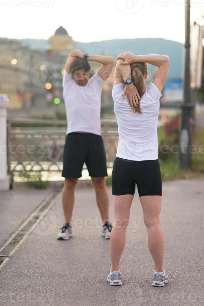 couple warming up before jogging photo