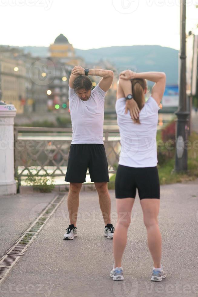 couple warming up before jogging photo