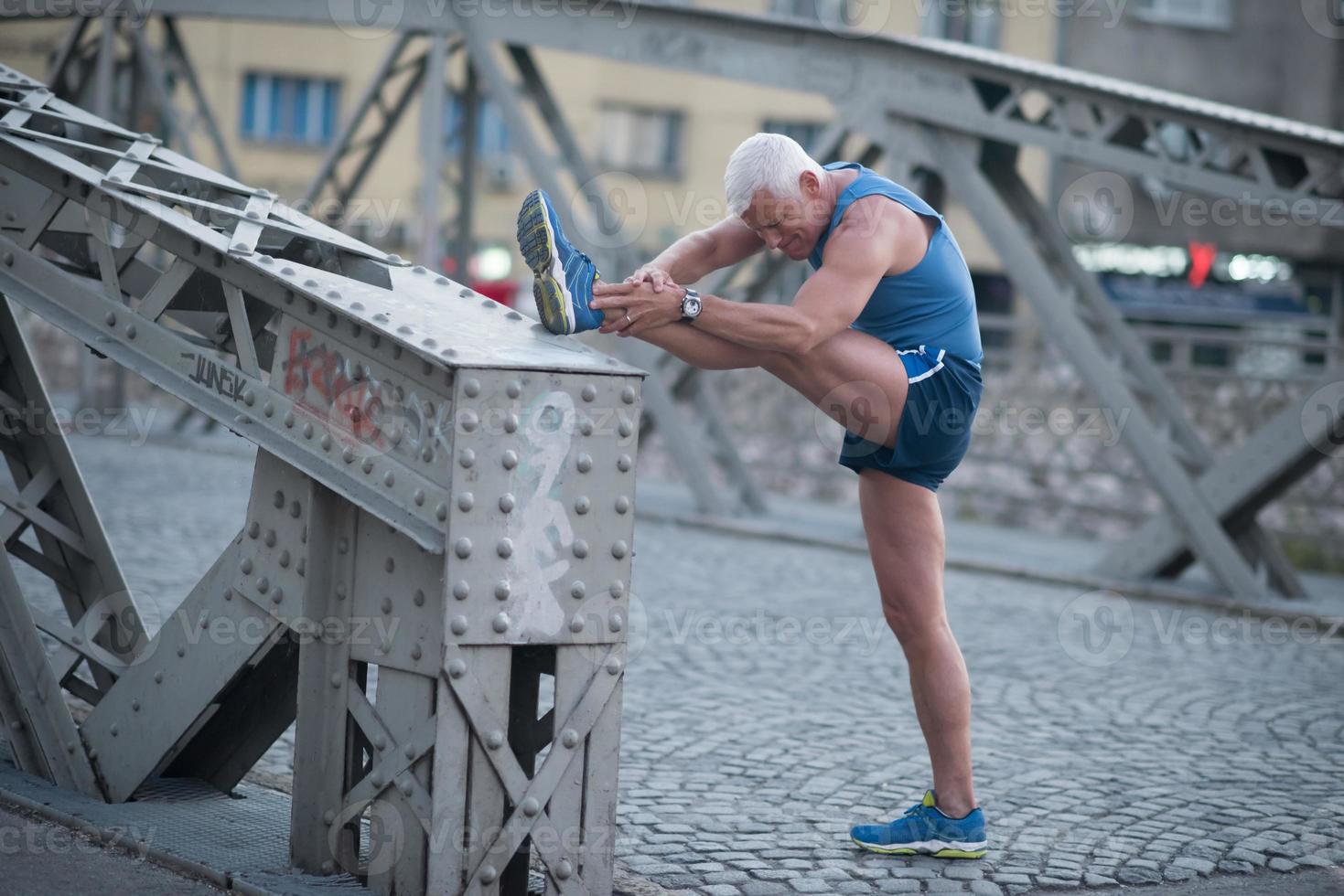 handsome man stretching before jogging photo