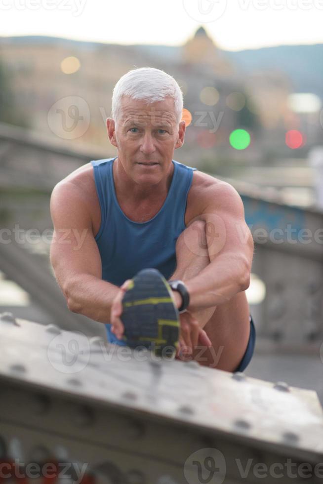 handsome man stretching before jogging photo