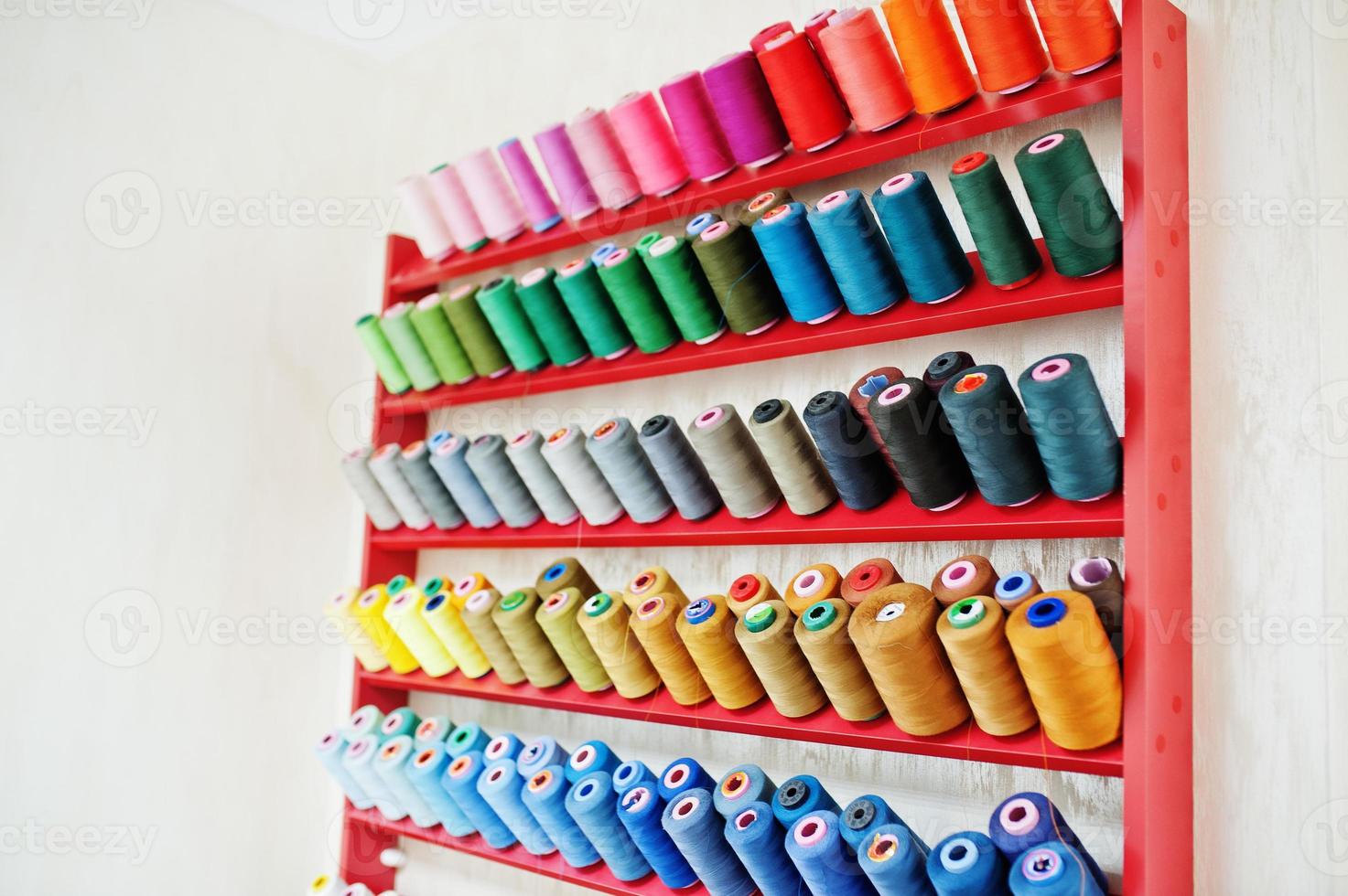 Colored thread coils on seamstess background, sewing. photo