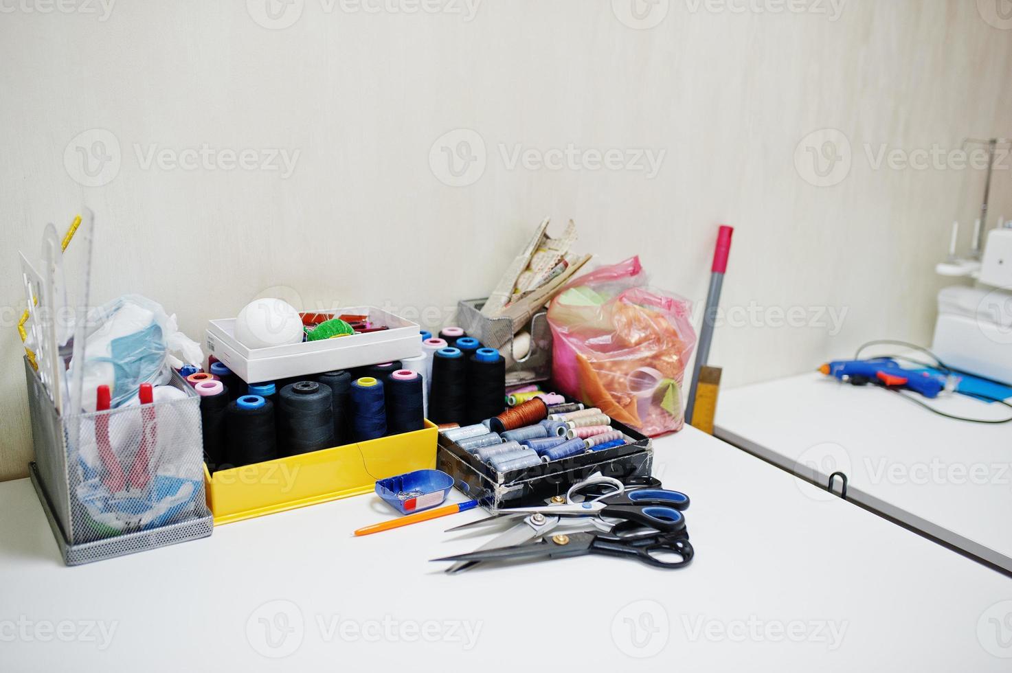 Creative fashion designer desk or workplace with sewing equipment. photo