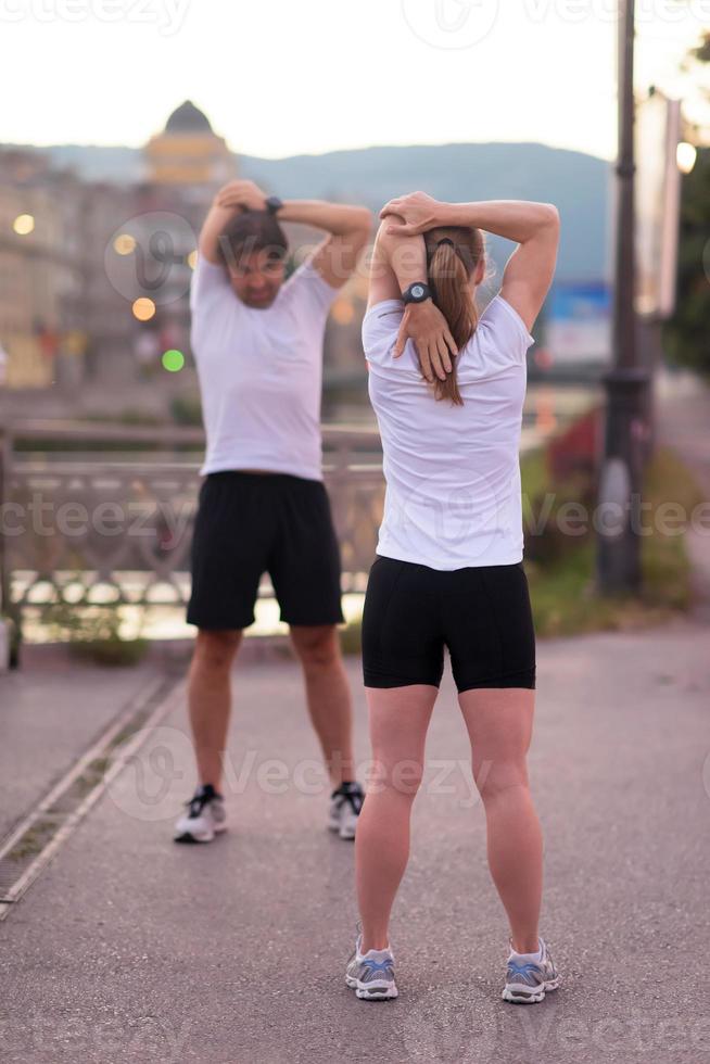 couple warming up before jogging photo