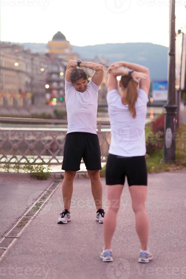 couple warming up before jogging photo