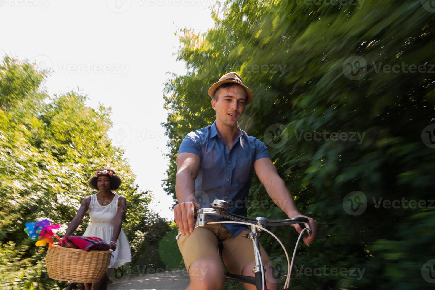 Young multiethnic couple having a bike ride in nature photo