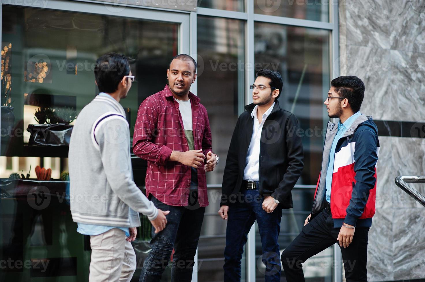 Group of four indian teen male students. Classmates spend time together. photo