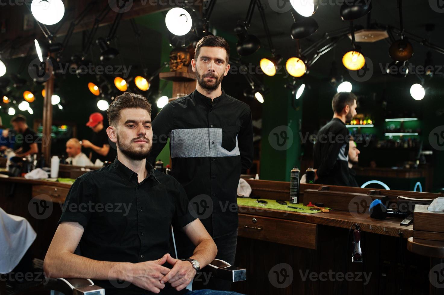 Handsome bearded man at the barbershop, barber at work. photo