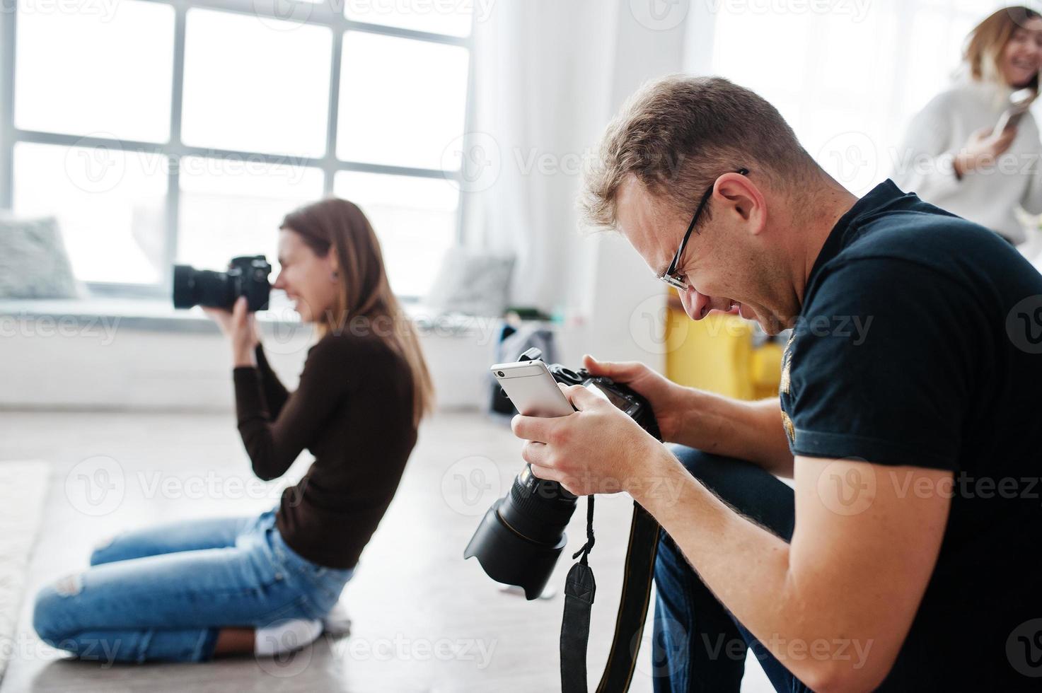 The team of two photographers shooting on studio. Professional photographer on work. photo