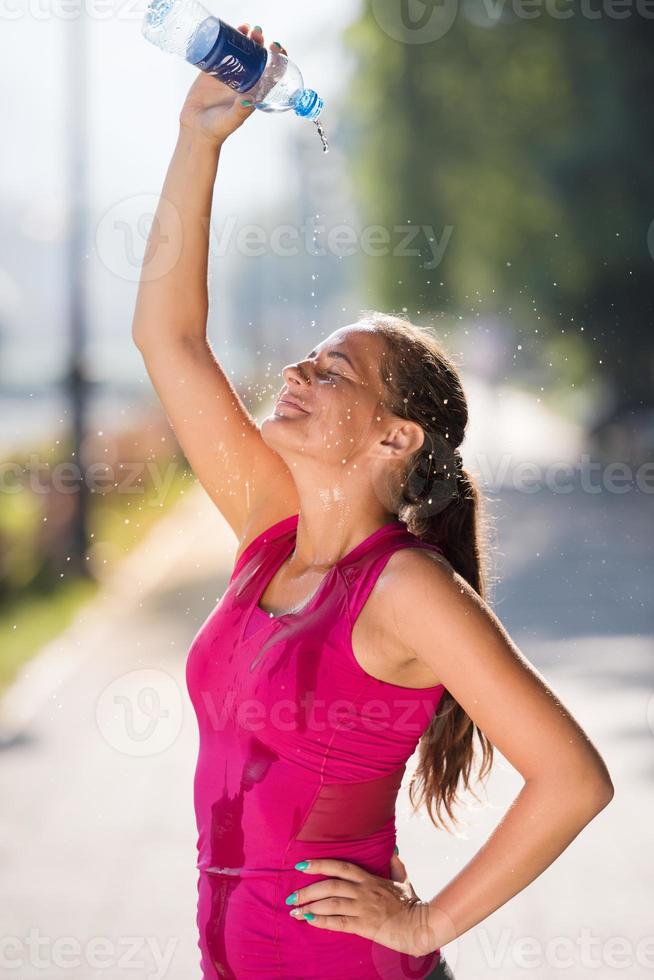 woman pouring water from bottle on her head 10418390 Stock Photo at