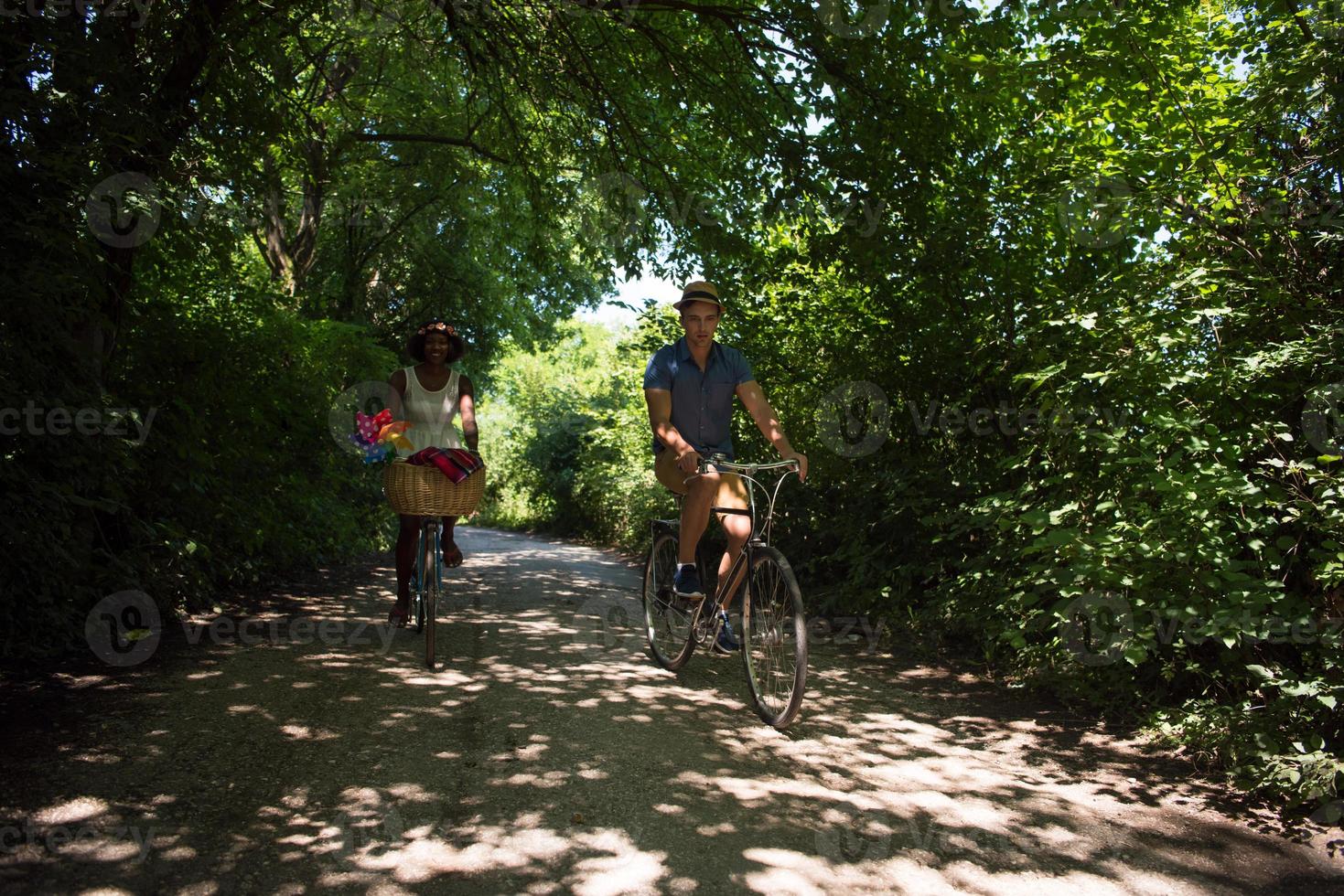 Young multiethnic couple having a bike ride in nature photo