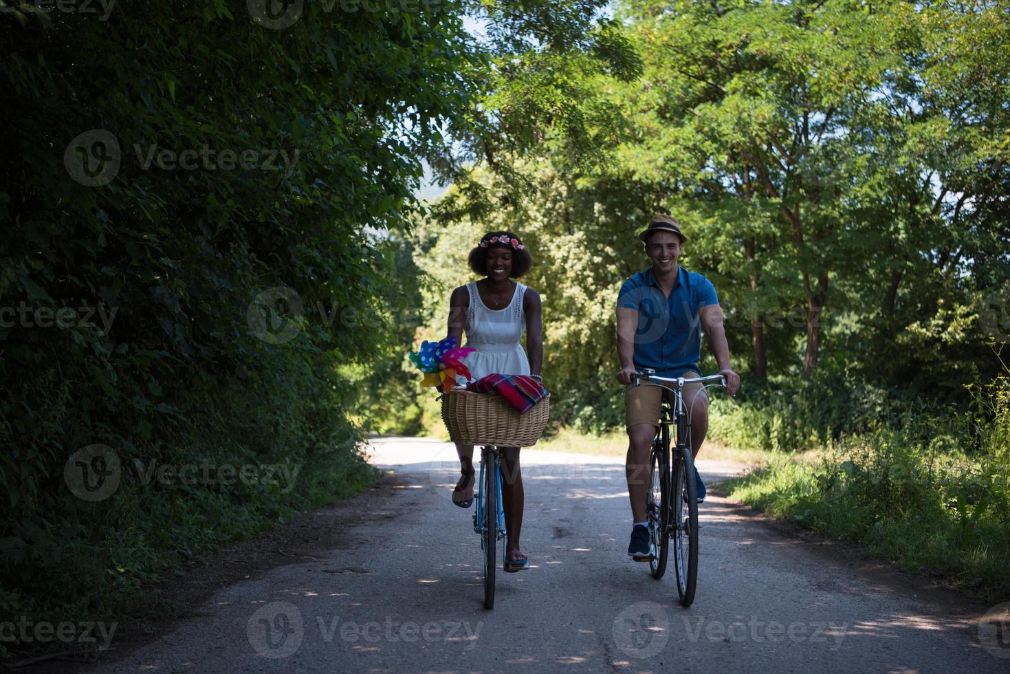 Young multiethnic couple having a bike ride in nature photo