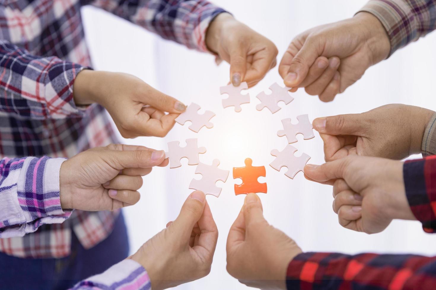 A group of business people assembling jigsaw puzzle. The concept of cooperation, teamwork, help and support in business. Team business success partnership. photo