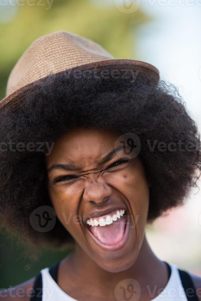 Close up portrait of a beautiful young african american woman smiling and looking up photo