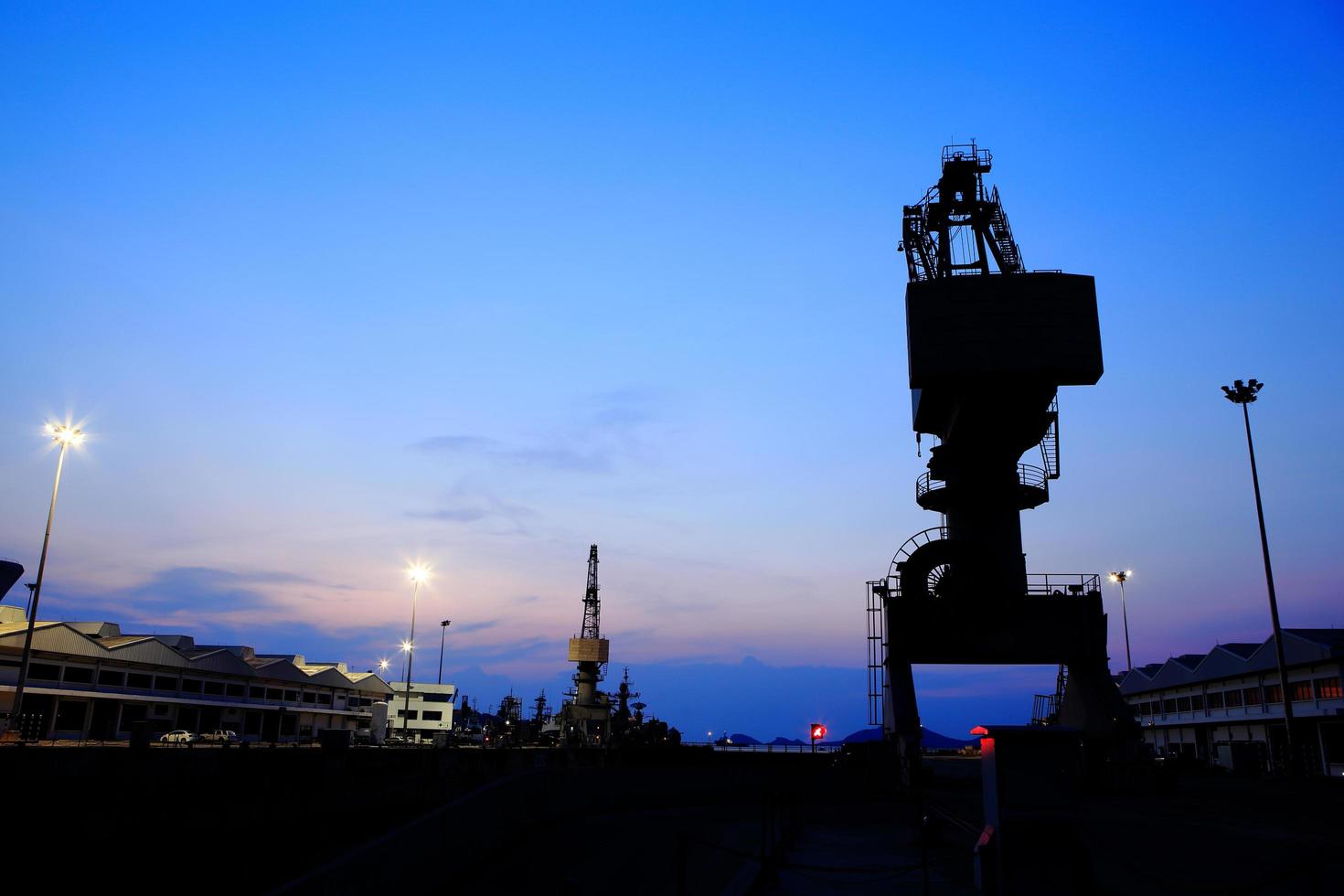 Cranes in dockside at sunset photo