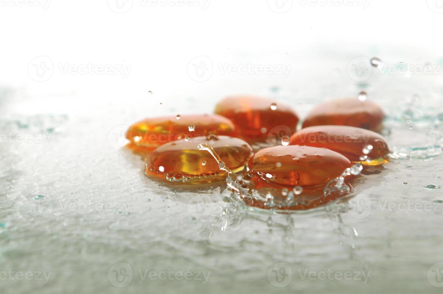 isolated wet zen stones with splashing  water drops photo