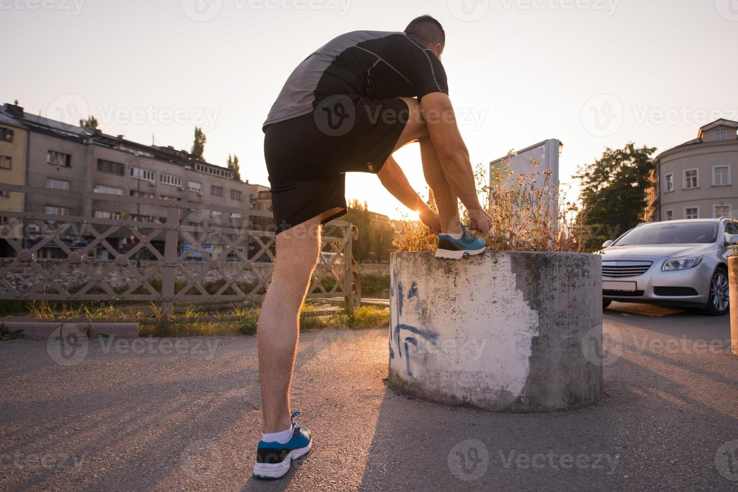 man tying running shoes laces photo