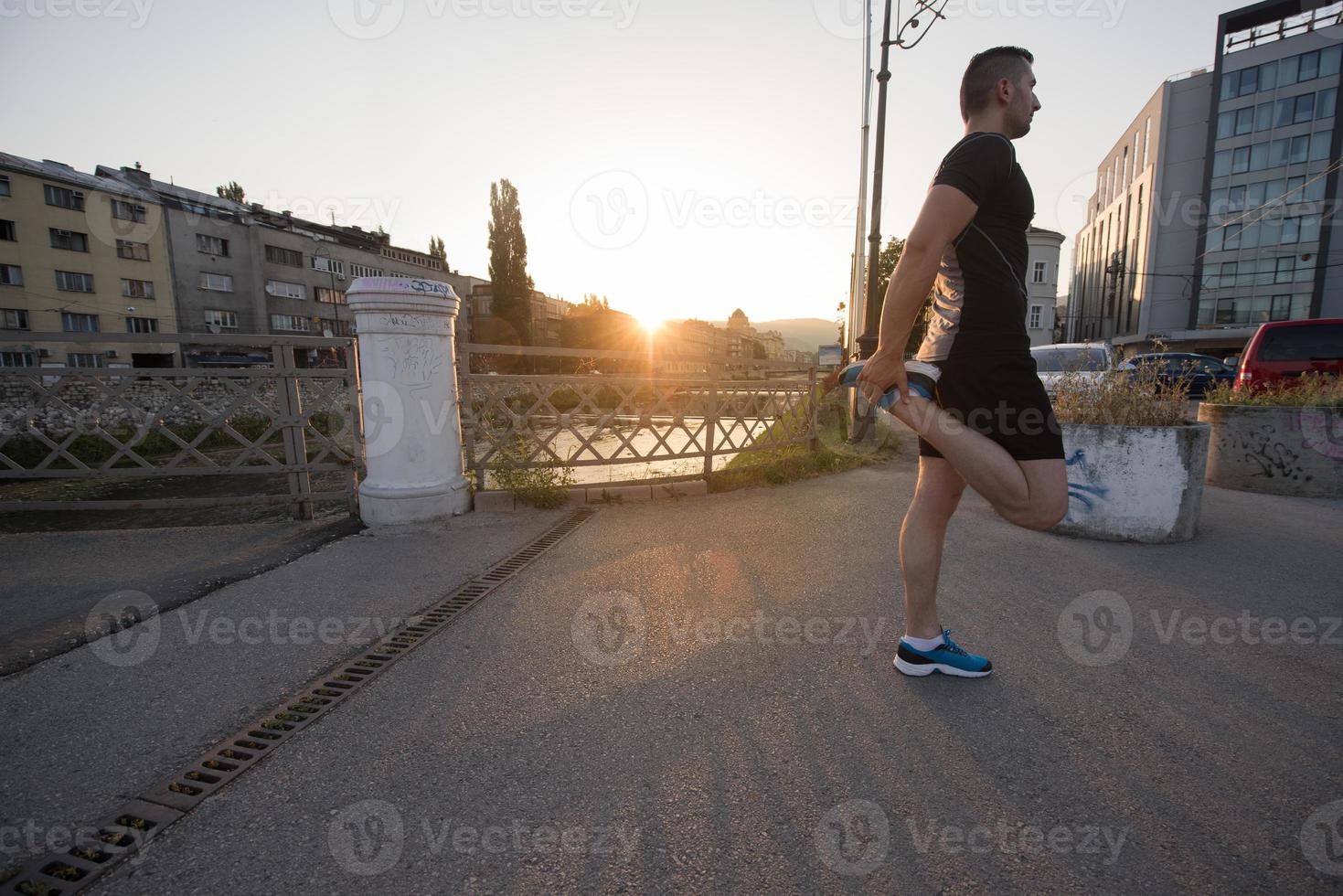 athlete man warming up and stretching photo