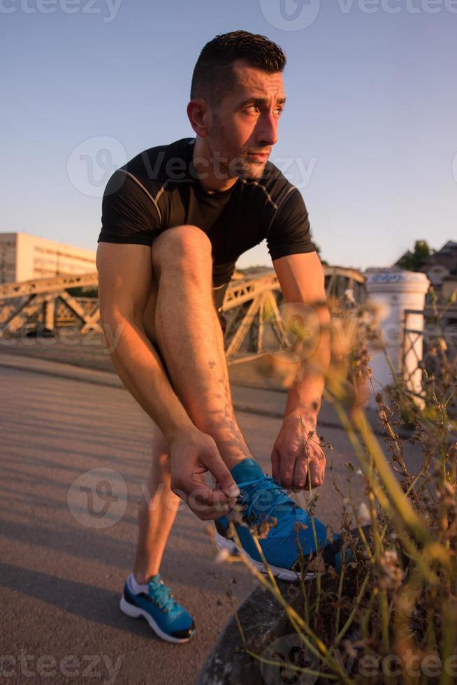 man tying running shoes laces photo