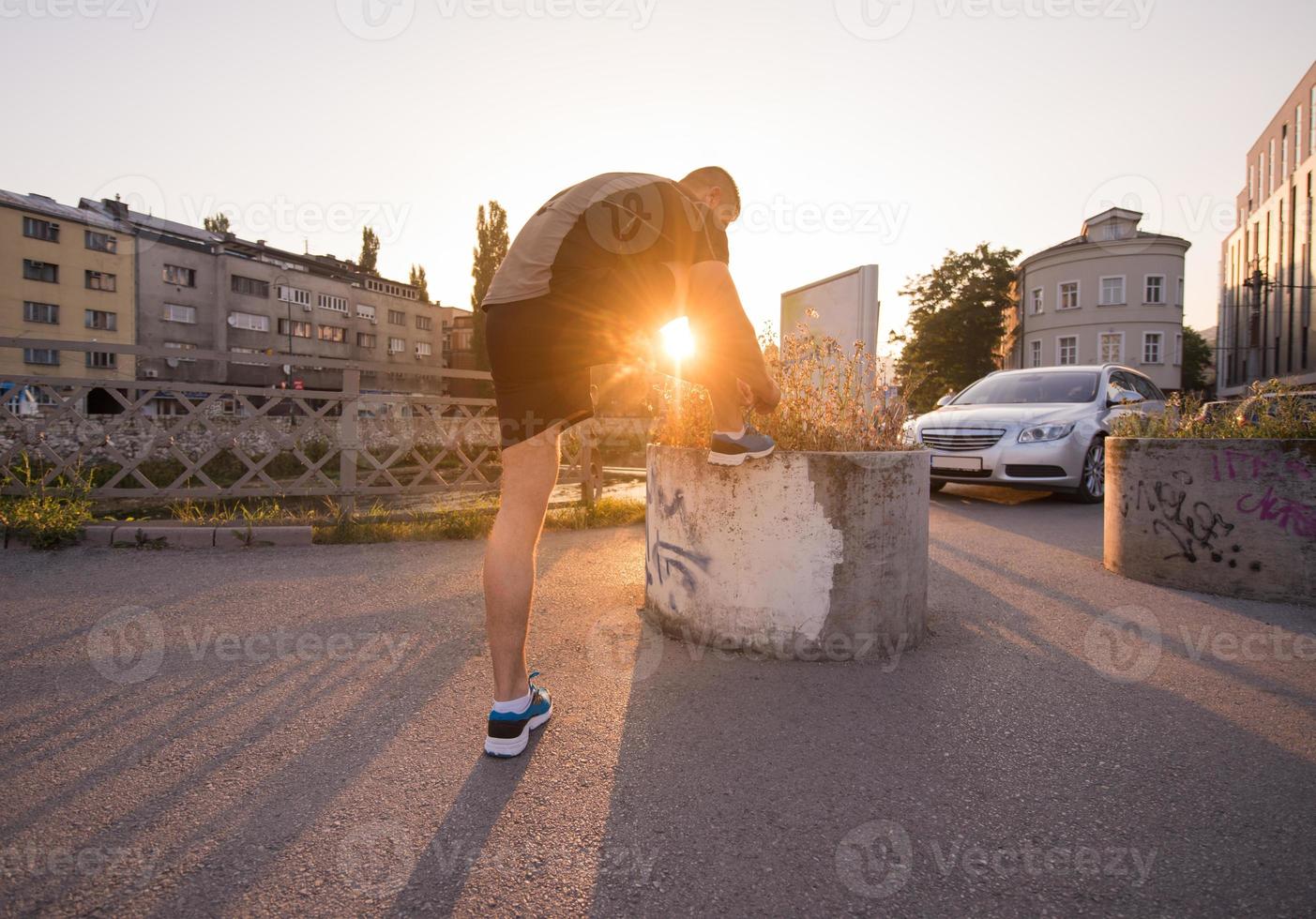 man tying running shoes laces photo