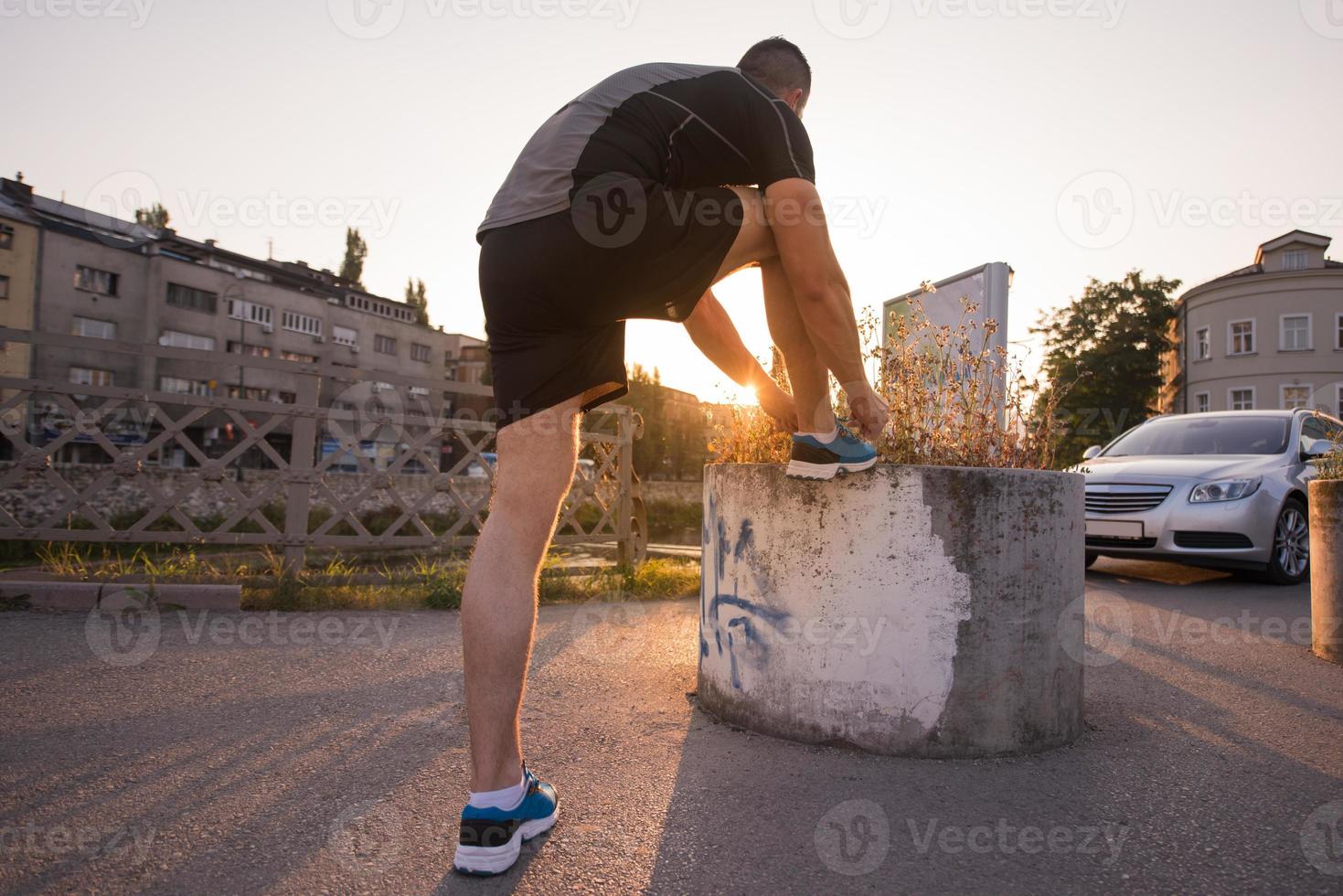 man tying running shoes laces photo