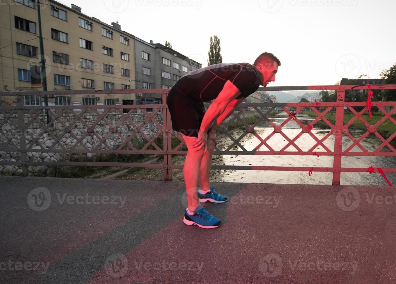 man jogging across the bridge at sunny morning photo